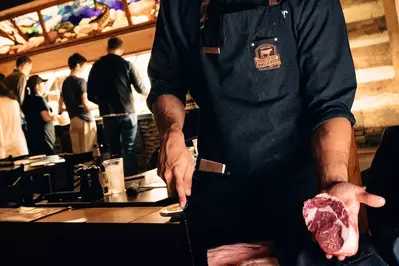 peddler holding cut of steak